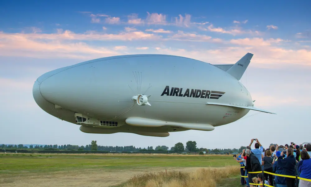 A crowd of people watching the Airlander coming into land.