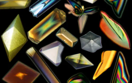 A collage of close ups of 16 crystals, all different shapes and colours due to polarised light.