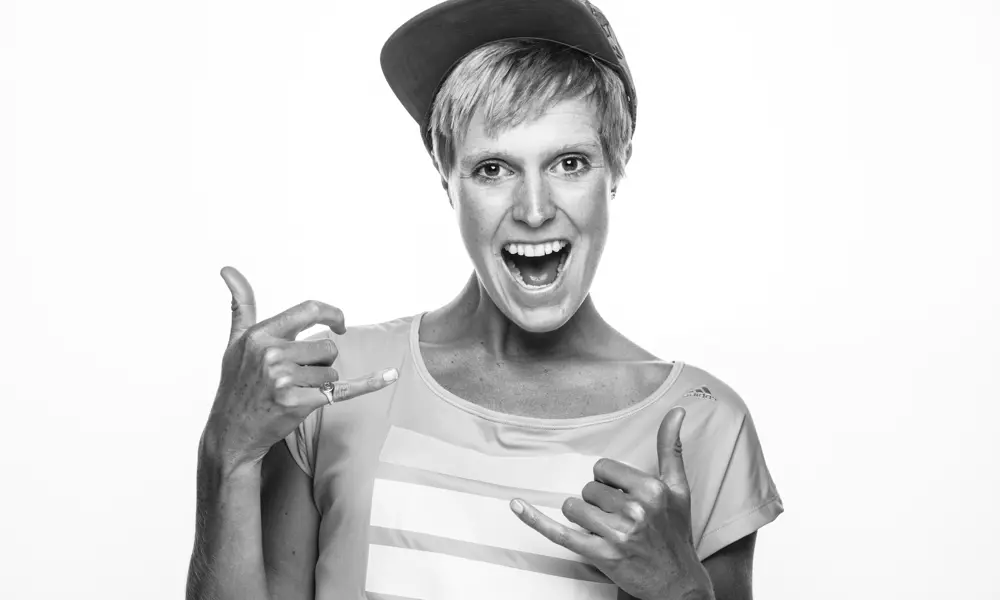 A portrait of Felicity Milton performing a rock on hand gesture.