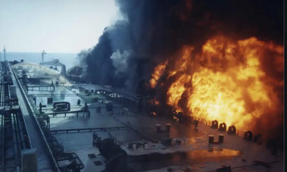 An explosion next to a large ship.