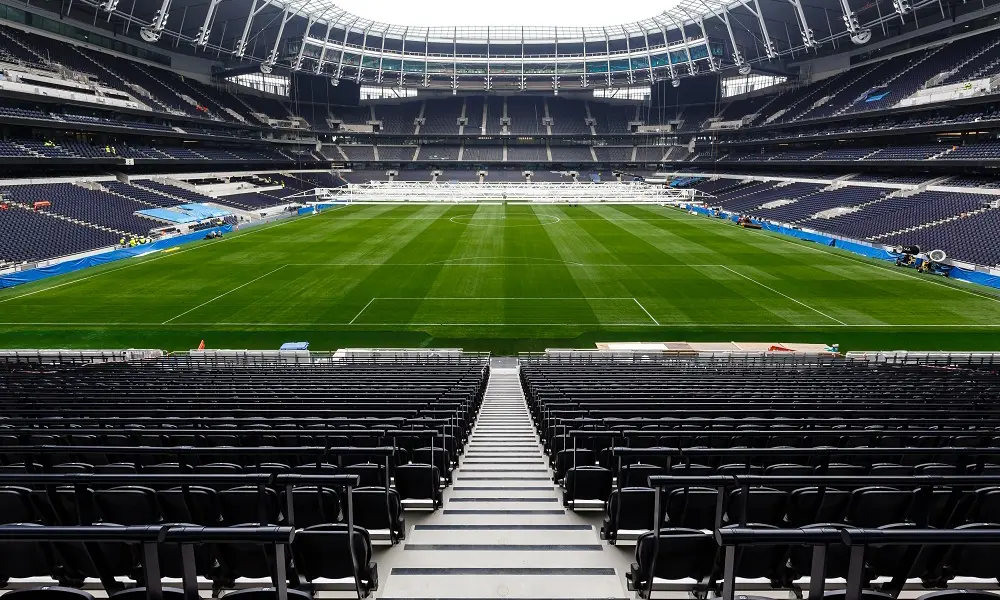 The empty chairs and football field at Tottenham Hotspur Stadium.