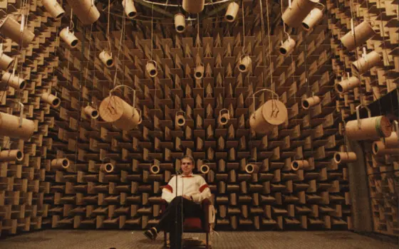 A person sitting in an anechoic chamber.