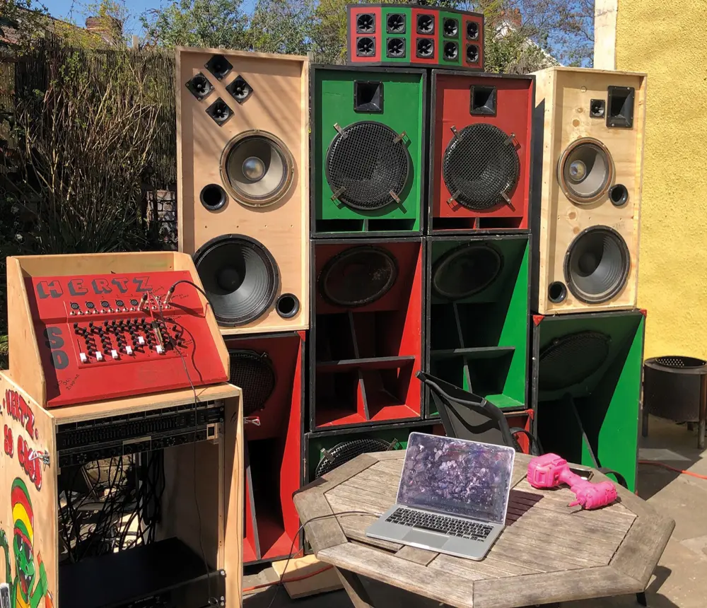 A soundsystem made from wood, painted red and green with "Hertz So Good" on the side.