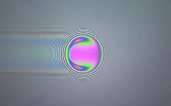 Coloured optical interference fringes around a ball.