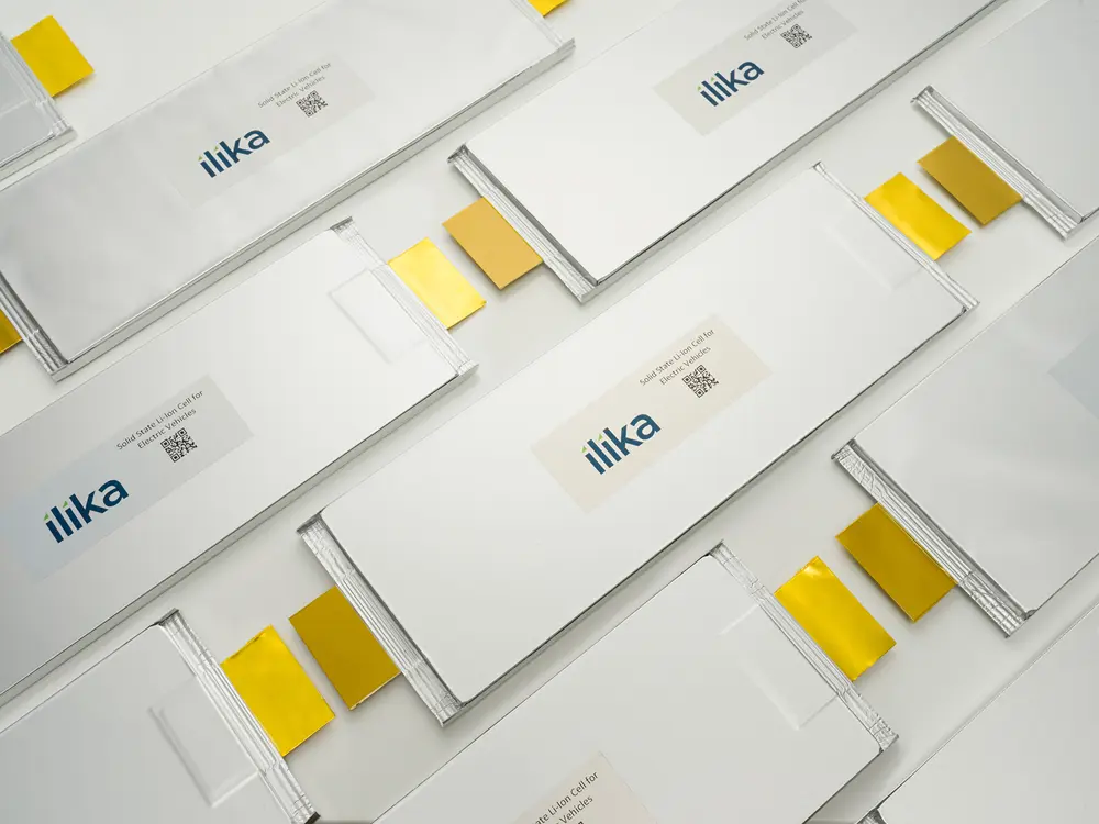 A number of silver rectangles are lines up in a tile pattern with smaller gold tabs at their ends