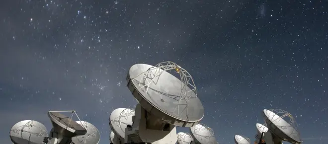 The ALMA antennas at night.