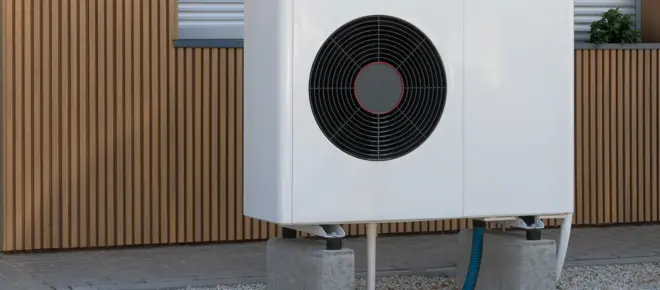 A ground air source heat pump outside of a building. 