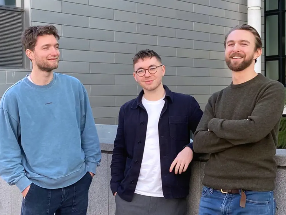 Steve Kench, Isaac Squires and Sam Cooper stand together, smiling and looking relaxed.