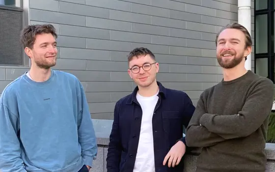 Steve Kench, Isaac Squires and Sam Cooper stand together, smiling and looking relaxed.