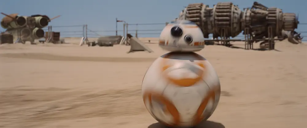 BB-8 moving in a desert landscape on the star wars set.