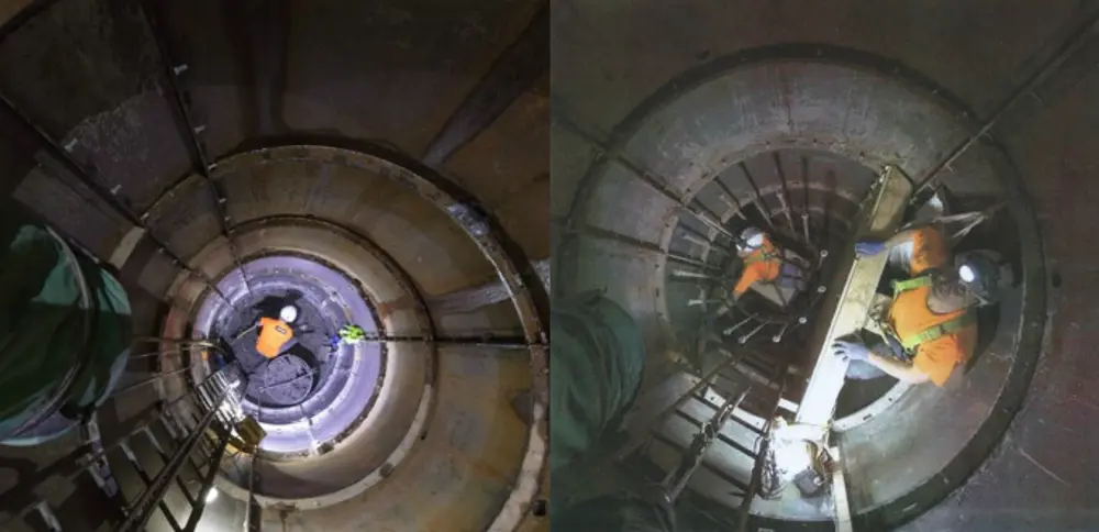 The inside of two caissons. On the left there is a miner at the end of a caisson. On the right there are two miners inside, one of whom is looking at the camera while holding onto a reinforcing bar.