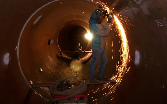 A welder in a tunnel at the CERN Neutrinos to Gran Sasso decay tube.