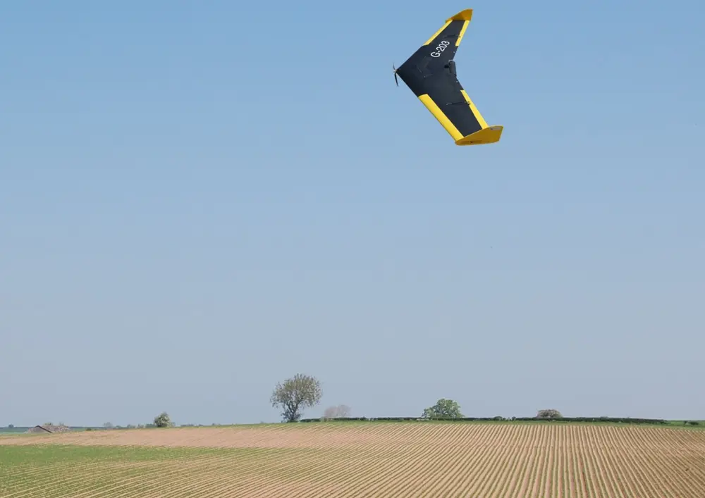 A drone flying over a field. 